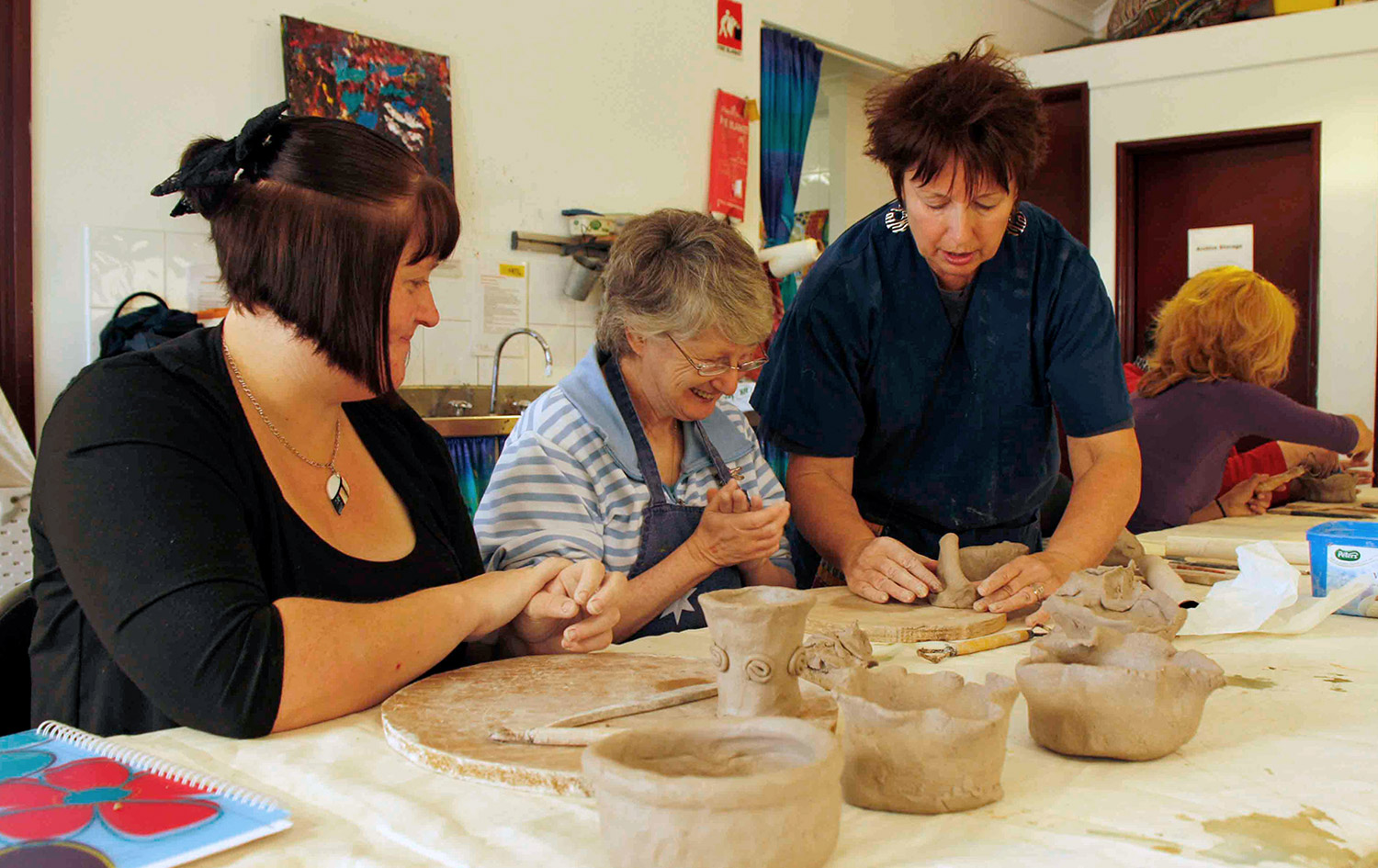 Participants creating clay works at As We Are's Clay Workshops, Victoria Park Centre for the Arts