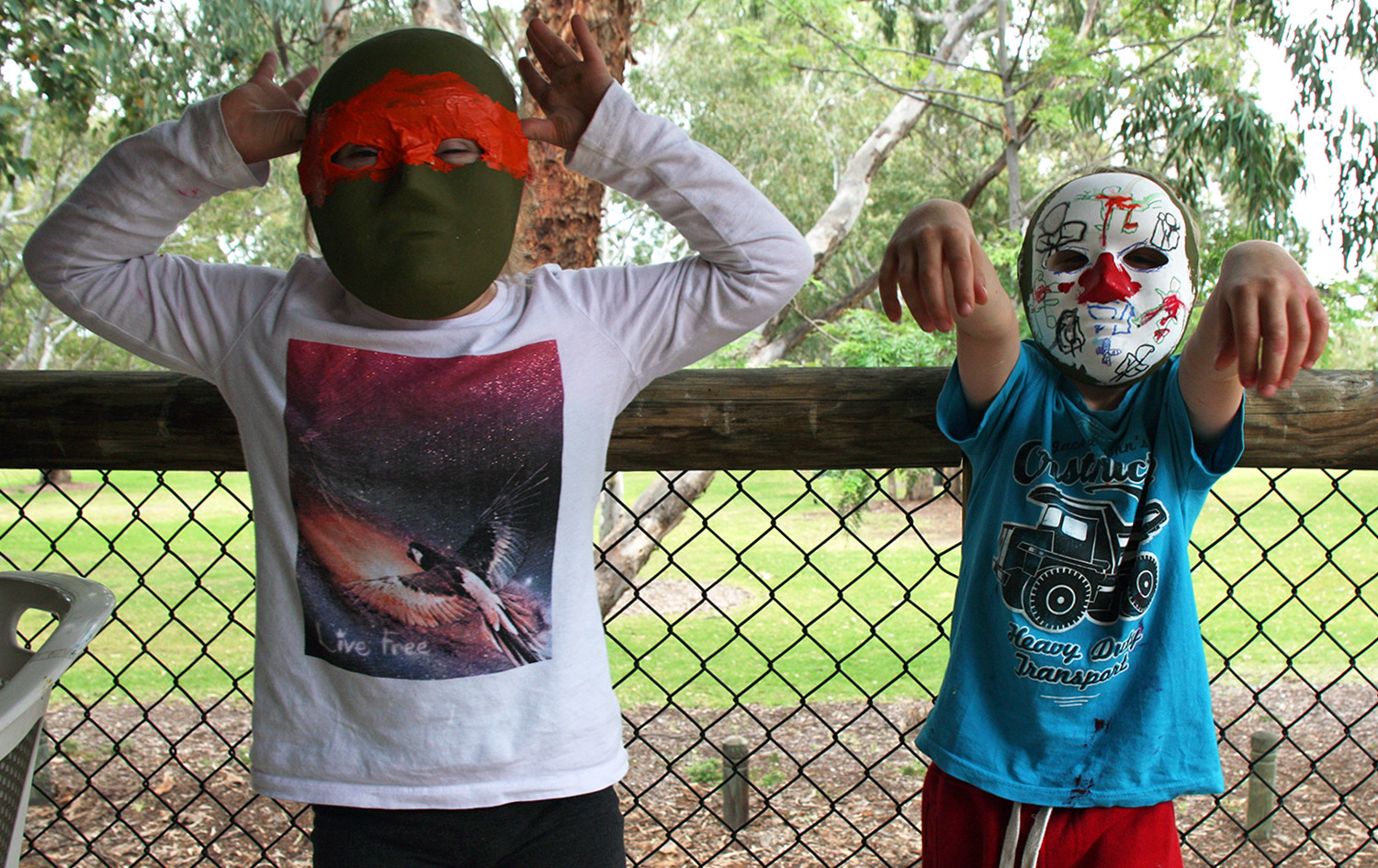 Children with hand-drawn face masks at As We Are's Children's Art Workshop, Garvey Park, Ascot