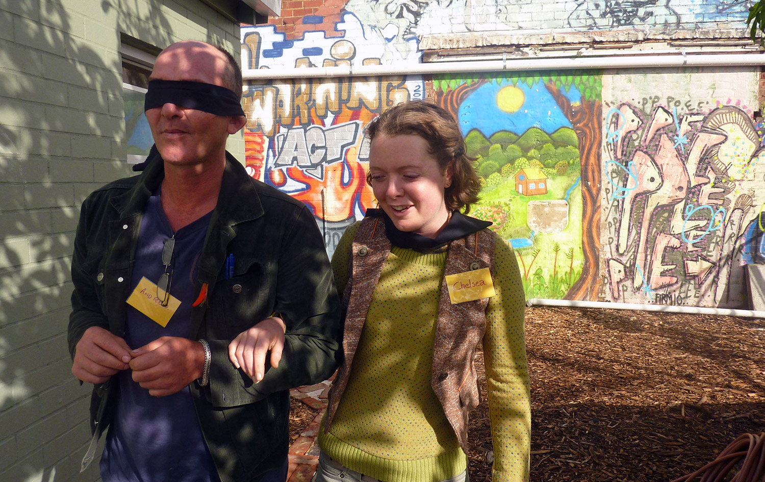 A blind-folded participant being led by fellow participant at the Walking and Mapping workshop, Perth City Farm