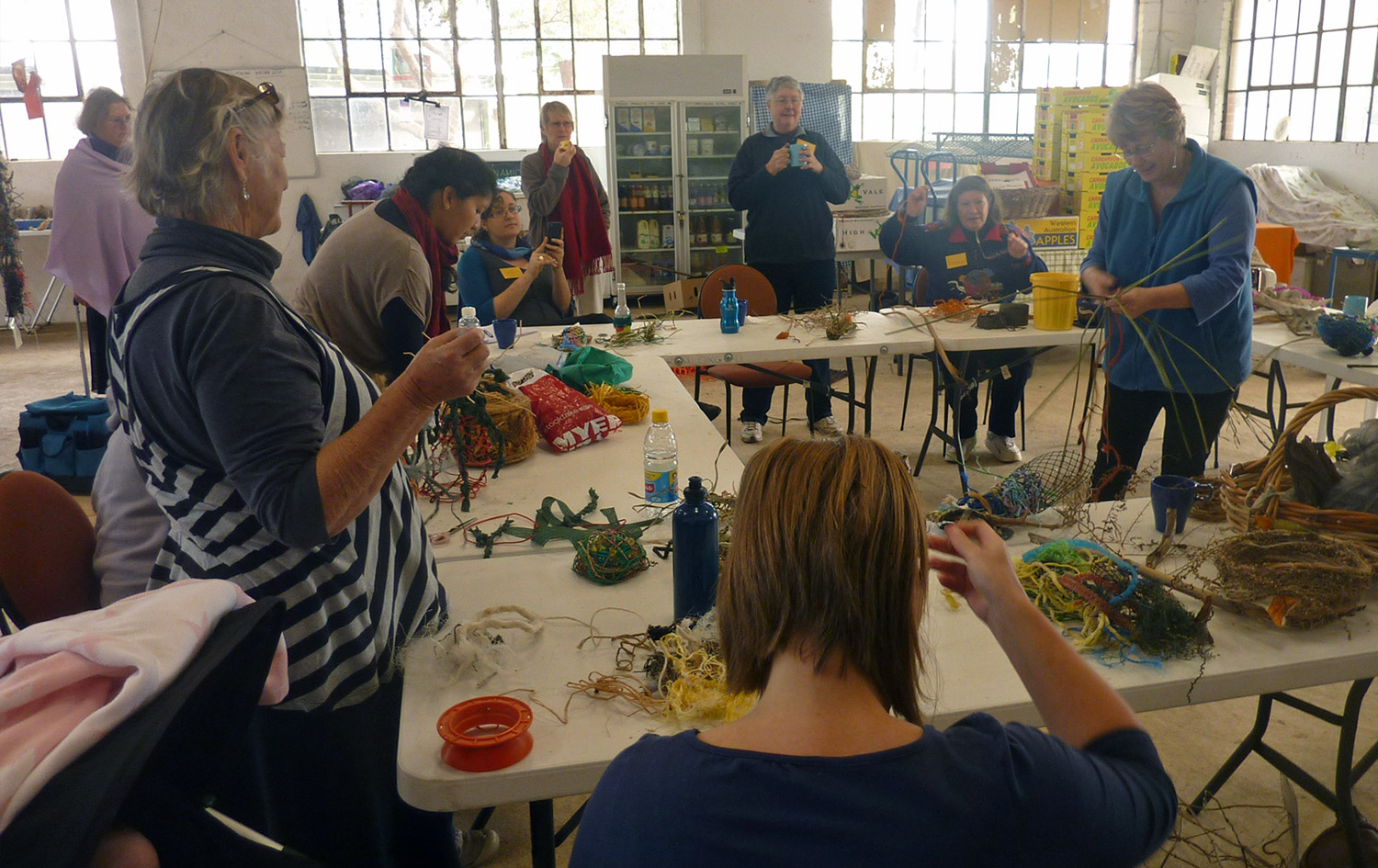 Joyce Tasma demonstrating weaving with participants, Perth City Farm