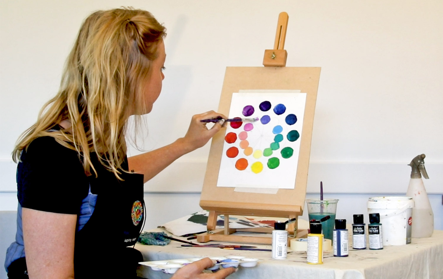 Artist Kate Leslie painting a colour wheel