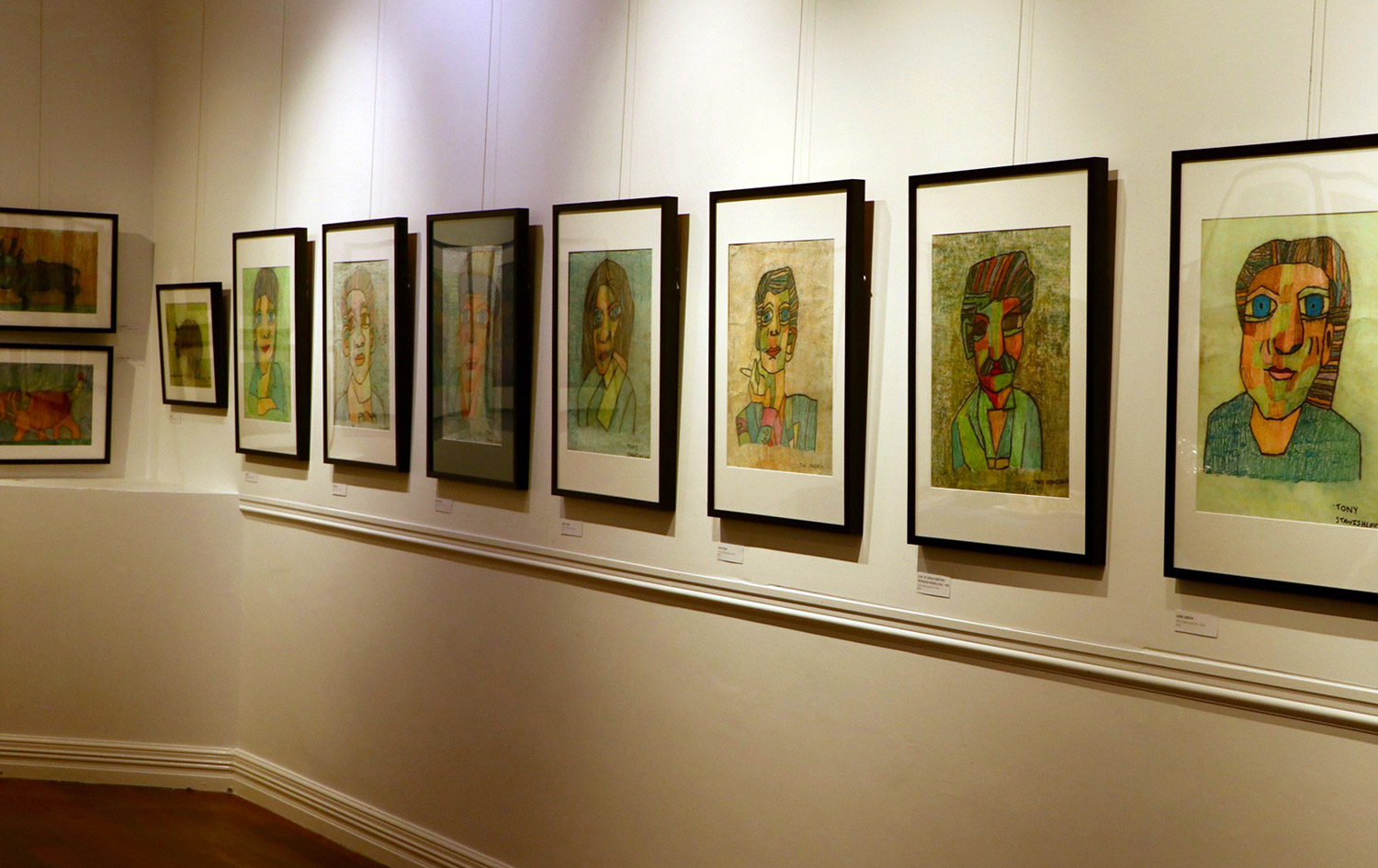 A number of Tony Stanisheff's portraits on display at his exhibition